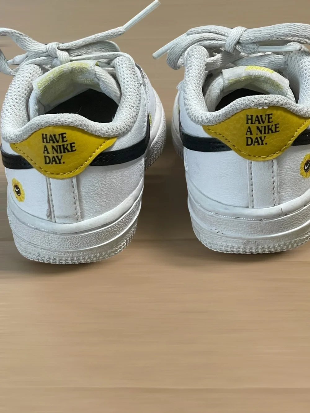 Nike Toddler White Sneakers with Black Swoosh and Yellow Star